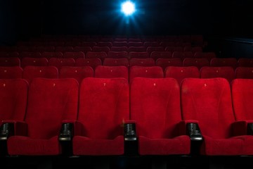 Empty comfortable red seats with numbers in cinema - obrazy, fototapety, plakaty