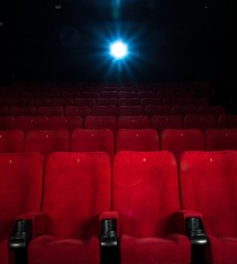 Empty comfortable red seats with numbers in cinema