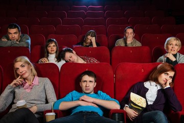 Group of boring people watching movie in cinema - 49673582