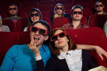 Obraz premium Group of people in 3D glasses watching movie in cinema