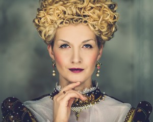 Portrait of beautiful haughty queen in royal dress