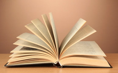 Opened book on color background