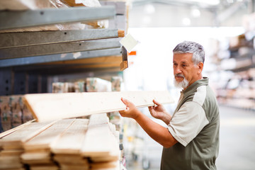 Senior man buying construction wood in a  DIY store