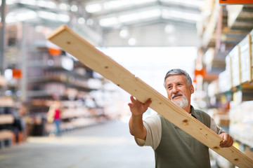 Senior man buying construction wood in a  DIY store