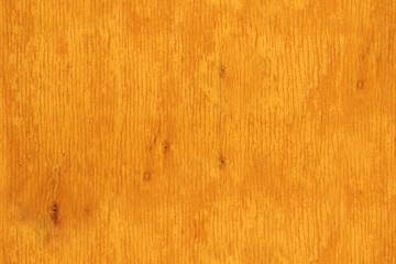 Fototapeta premium Yellow orange background. Cracked wood board texture