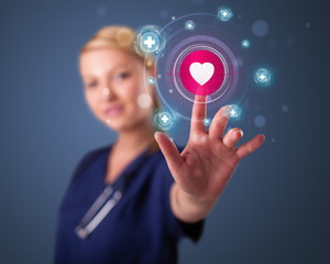 Young nurse pressing modern medical type of buttons