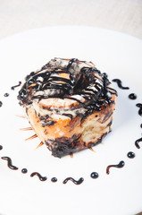 cinnamon roll drizzled with chocolate syrup