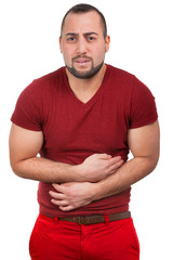Fototapeta premium Mann mit starken Schmerzen im Bauch krümmt sich