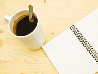Cup of coffe and spiral note book