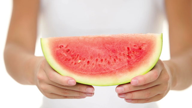 Watermelon - woman showing slice of watermelon