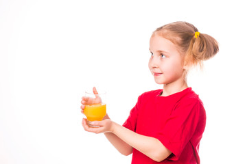 Cute little girl holding glass with juice smiling