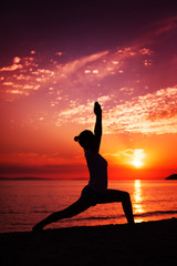 Woman Practicing Yoga at Sunset