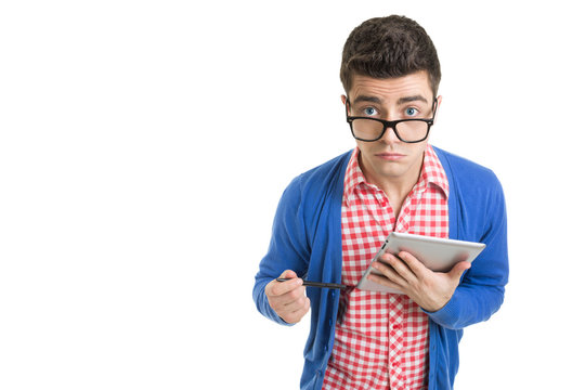 Confused fashionable young man using digital tablet