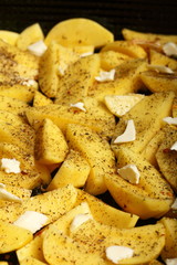 Raw potatoes with spices ready to be roasted