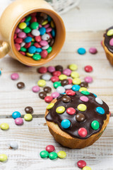 Easter muffins with candies and chocolate glaze