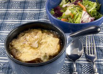 Bowl of onion soup and salad