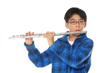asian boy plays a flute on white background