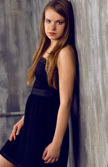 Fototapeta premium Beautiful blonde near the wall