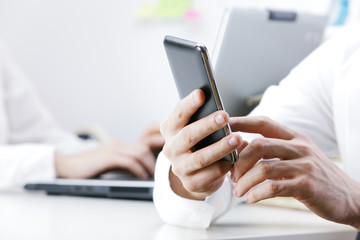 businessman using smart phone in office