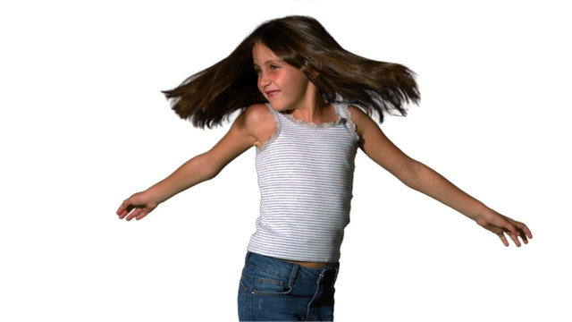 Little girl twirling on white background