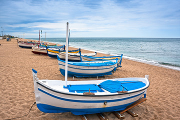 Fototapeta na wymiar View of a boat in on a beach in Calella, Spain