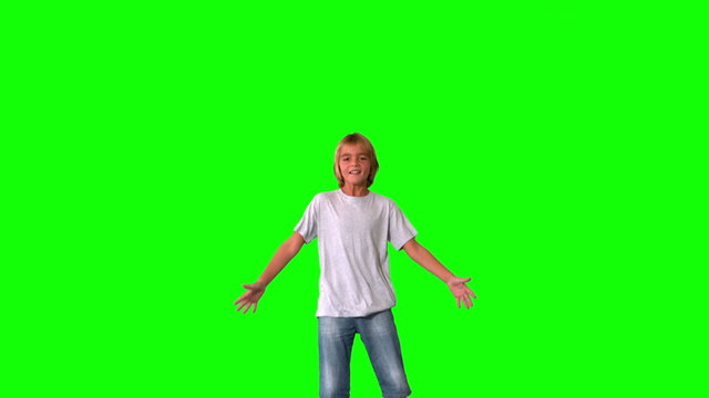 Boy jumping up and down on green screen