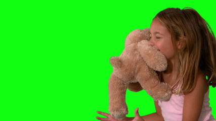 Cute little girl catching teddy bear on green screen and jumping - Powered by Adobe