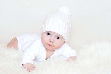 The baby in a white knitted hat