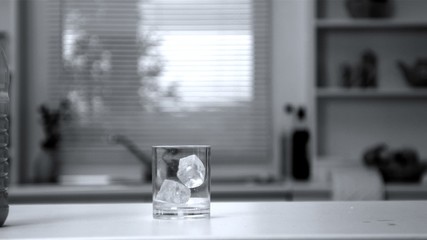 Two ice cubes falling in an empty glass - Powered by Adobe