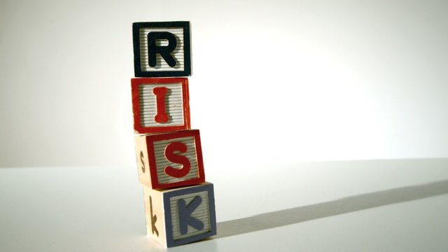 Risk spelled out in blocks falling over