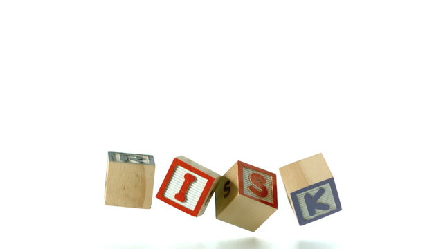 Risk spelled out in letter blocks falling in a row