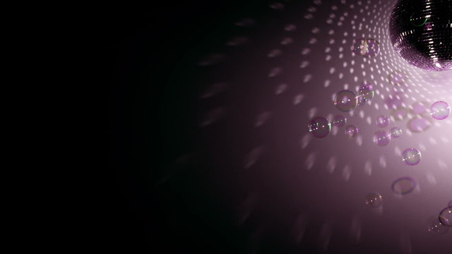 Shiny disco ball revolving with floating bubbles