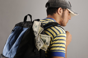 Obraz premium Young arabic man with backpack filled with money
