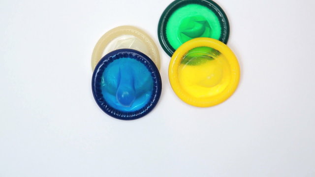 Condoms thrown on white surface