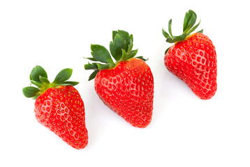 Three bright fresh strawberries isolated on white
