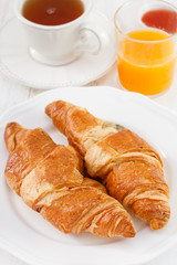 croissant with tea, juice and jam