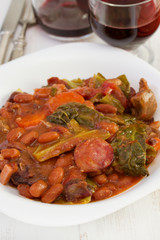Fototapeta premium stew in the plate with glass of red wine