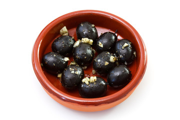 black olives with garlic in ceramic dish