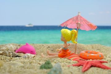 Girl under the sun umbrella on the beach