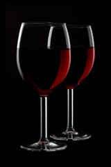 Two glassed of red wine isolated on black background