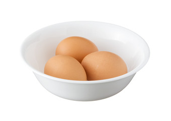 Three brown eggs in a bowl isolated on white background