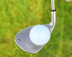 a golf ball in the grass ready to be hit