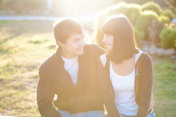 happy smiling couple against sun lite