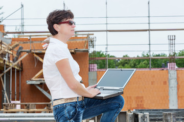 Civil engineer with a laptop on site