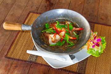 Thai dish with king prawns and noodles on the pan