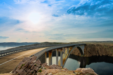 Bridge to the Pag island with sun and clouds, Croatia