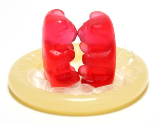 Red jelly figurine on a condom - birth control concept.