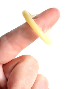 The condom on the finger - safe sex and contraception concept.