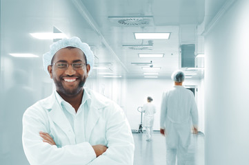 Working people with white uniforms in modern facility
