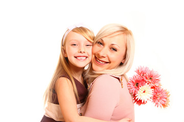 Happy mother and daughter hugging with flowers isolated on white